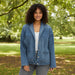 Woman wearing a blue denim jacket on a white background