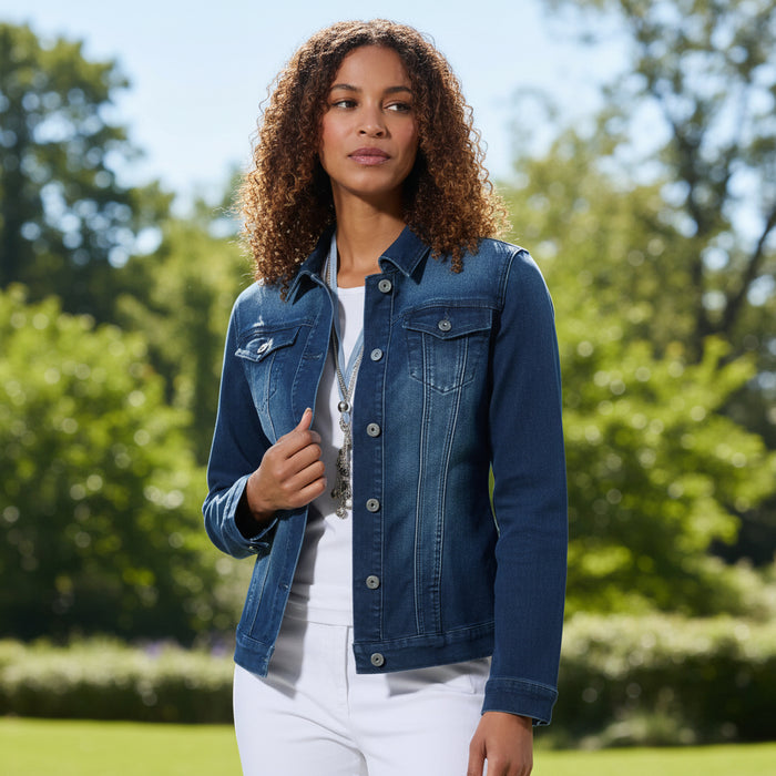 Woman wearing a blue denim jacket over a white shirt on a white background