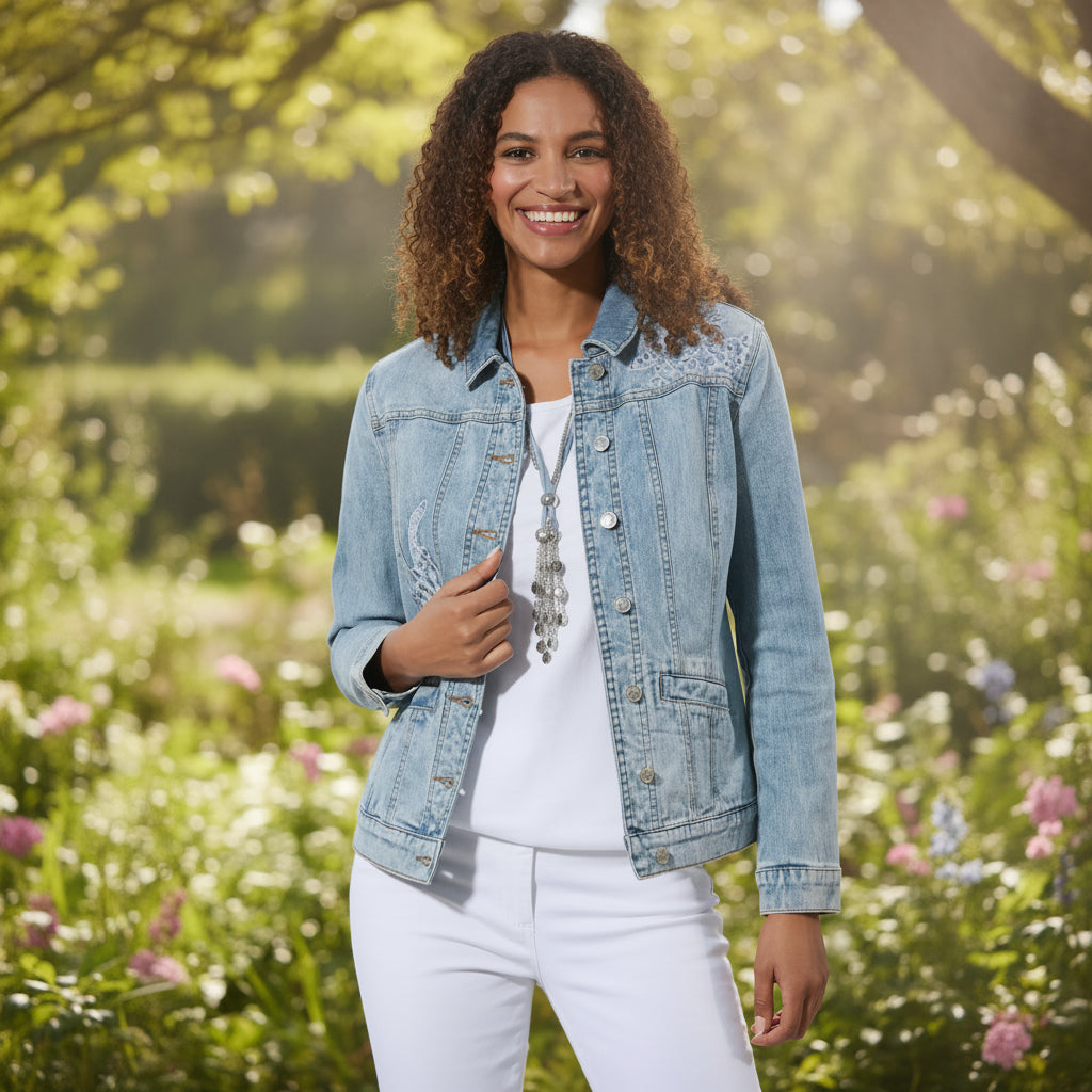 Woman wearing a light blue denim jacket on a white background